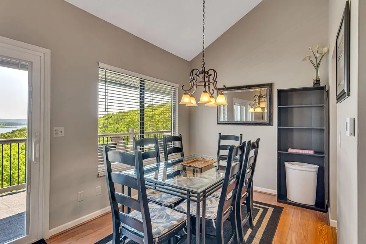 A dining area with a handsome table and chandelier, positioned by a window that offers enticing views. The scene is set for shared meals or cozy morning coffees, and the ambiance is welcoming and elegant.